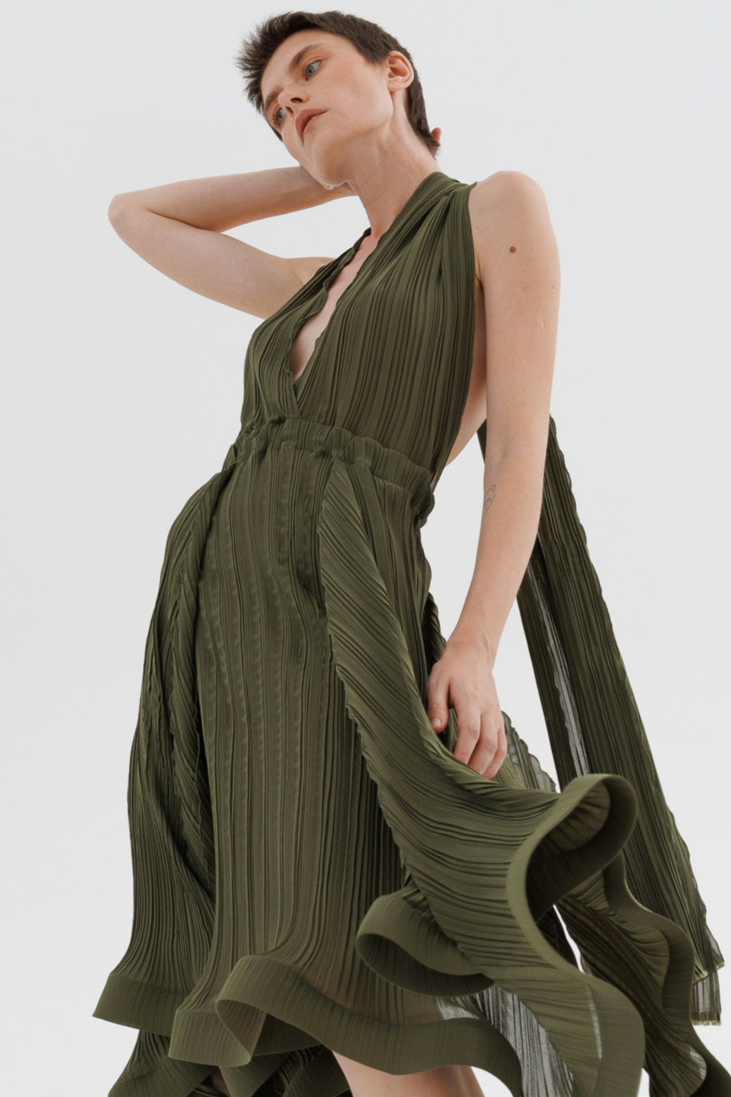 Woman wearing a green dress on a white background